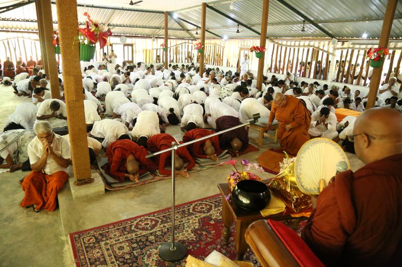 Devotees paying homage to the Sangha