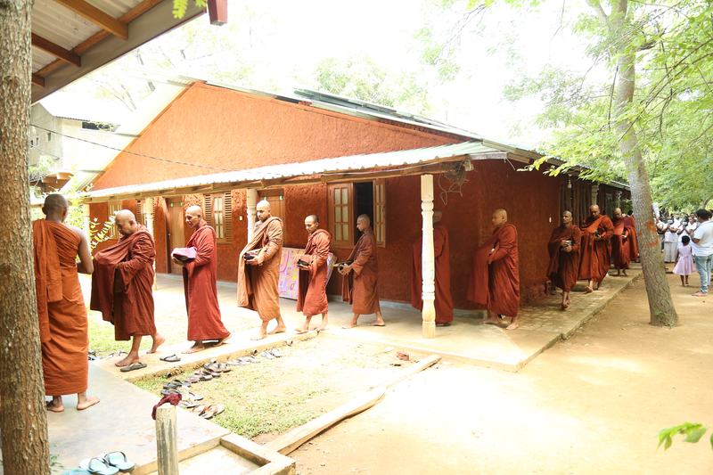 Monks walking in procession to the alms-giving